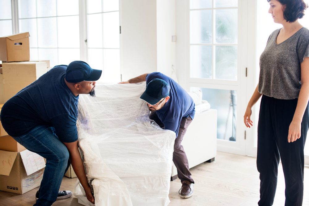 woman supervising professional movers from a moving company 