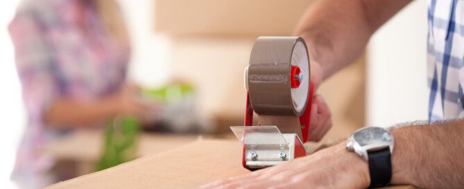 man tapes up box, find moving boxes for free