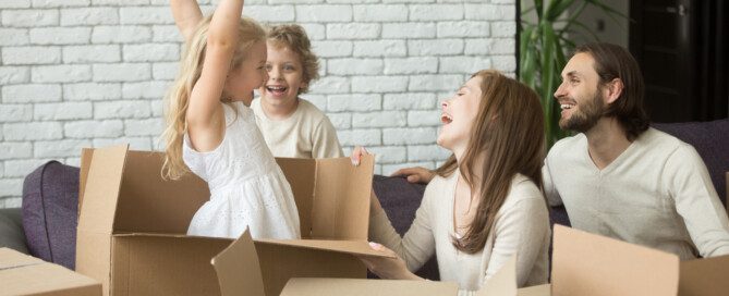 family playing with leftover moving boxes