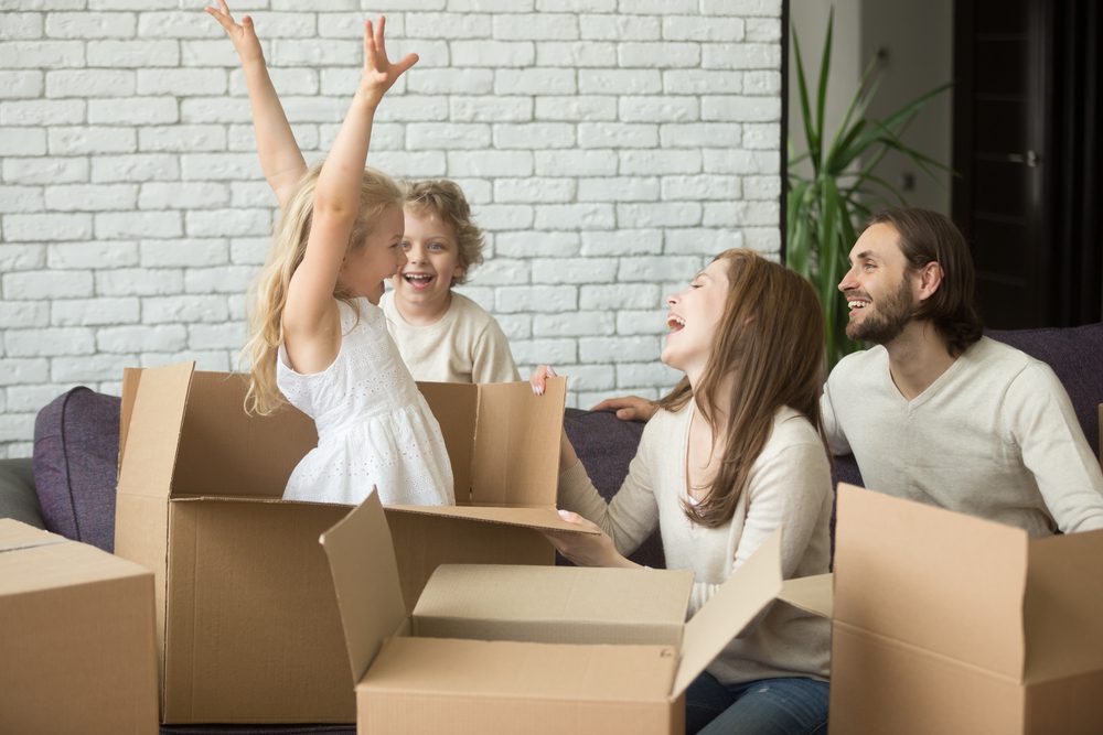 family playing with leftover moving boxes after working with a moving company Henderson