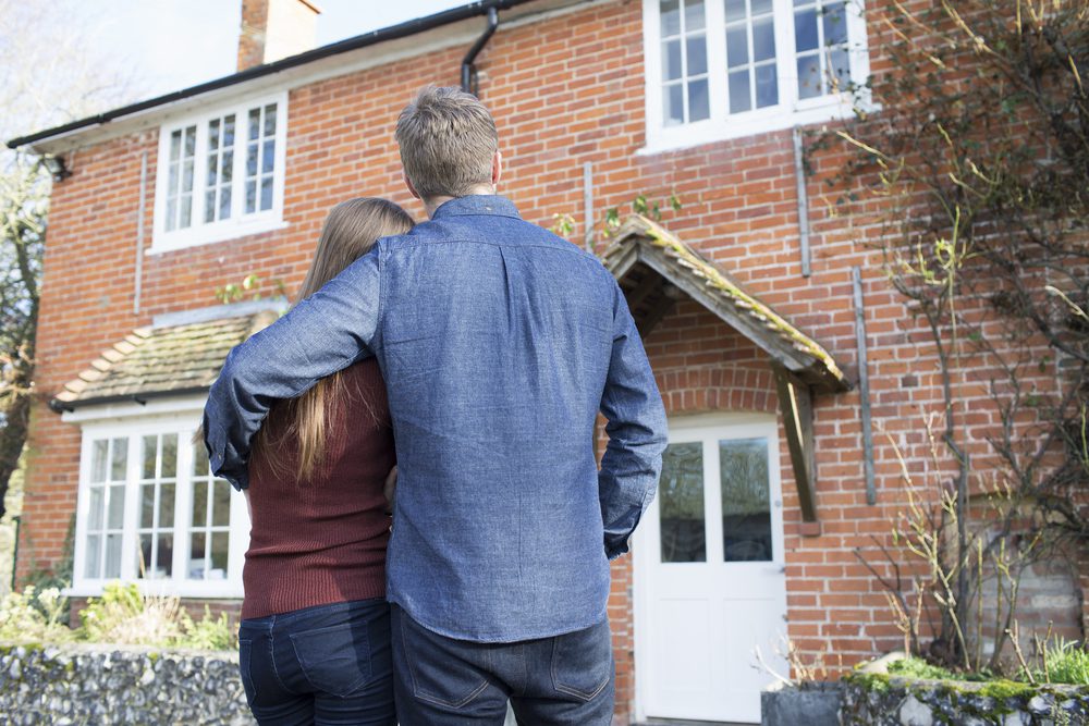 homeowners looking at newly purchased home after using a moving company