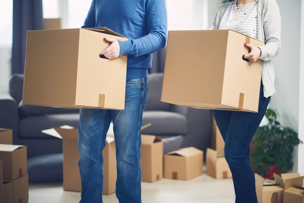 first-time home buyers moving into their new home with help from a moving company
